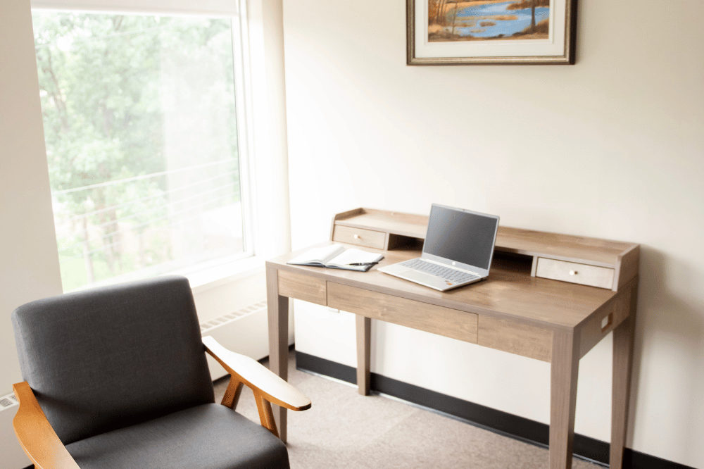 armchair and desk with laptop