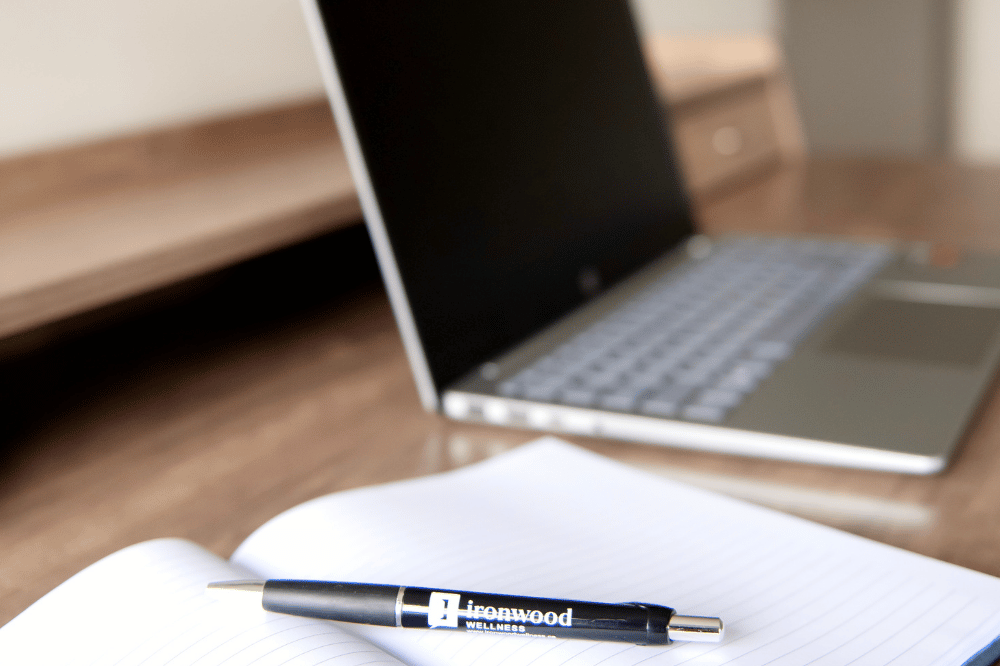 laptop and notebook with pen